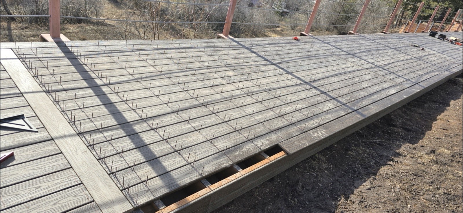 Large Trex composite deck installation in progress with picture-frame border, Flathead Valley Montana