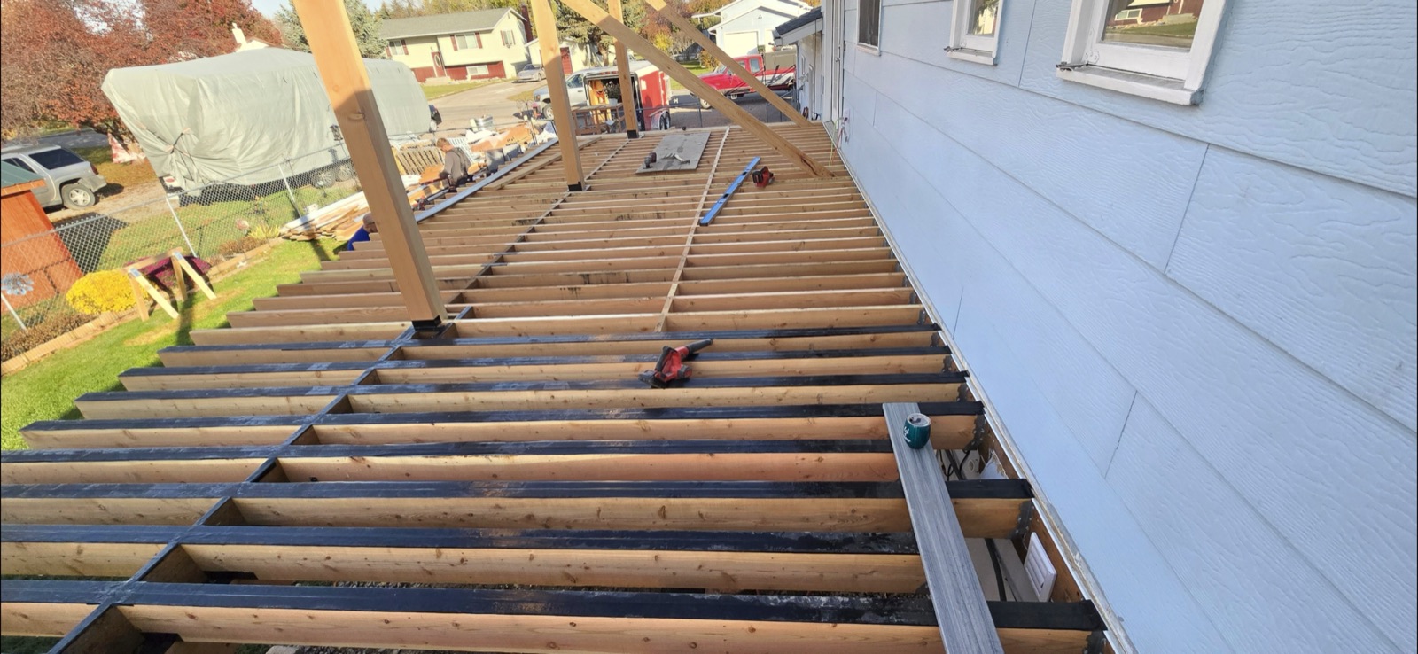 Deck joist framing with protective joist tape installed by Western Rockies Construction