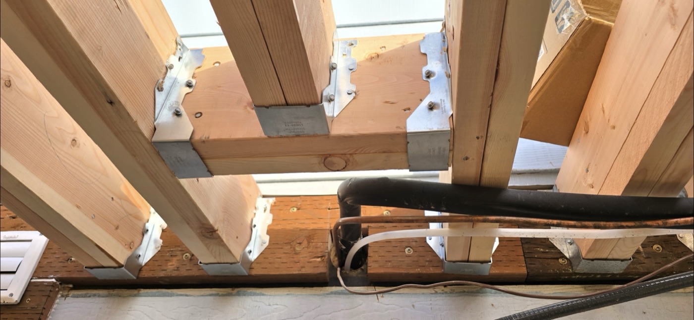 Joist hangers and structural hardware on deck framing