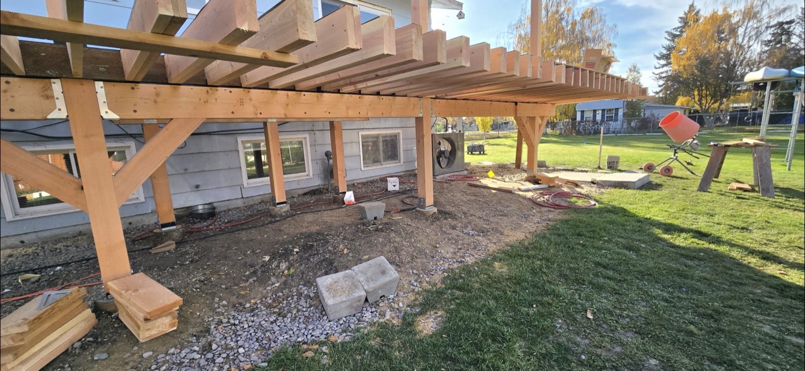Heavy timber post-and-beam framing for an elevated deck on a Montana home, built by Western Rockies Construction